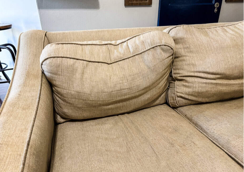 Sagging couch cushions showing foam degradation and loss of support